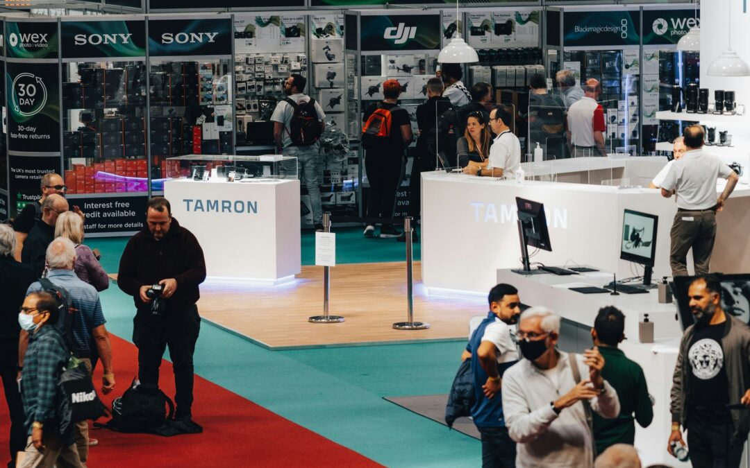 Attendees talking with exhibitors at a trade show booth