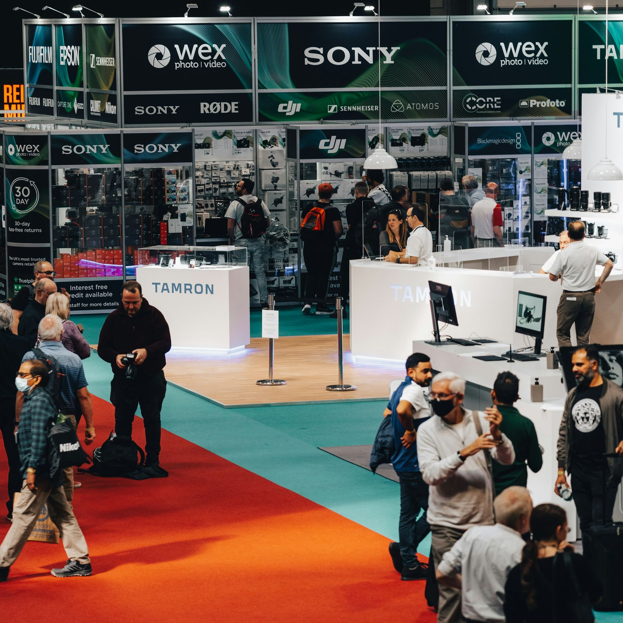 Attendees talking with exhibitors at a trade show booth